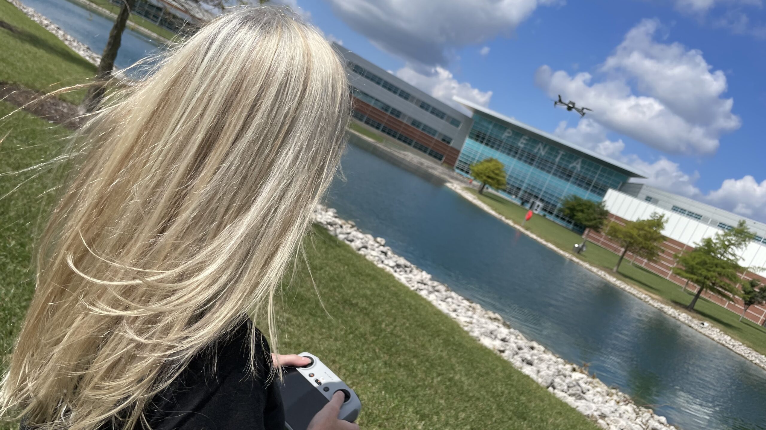 Woman Flying a Drone in the Distance