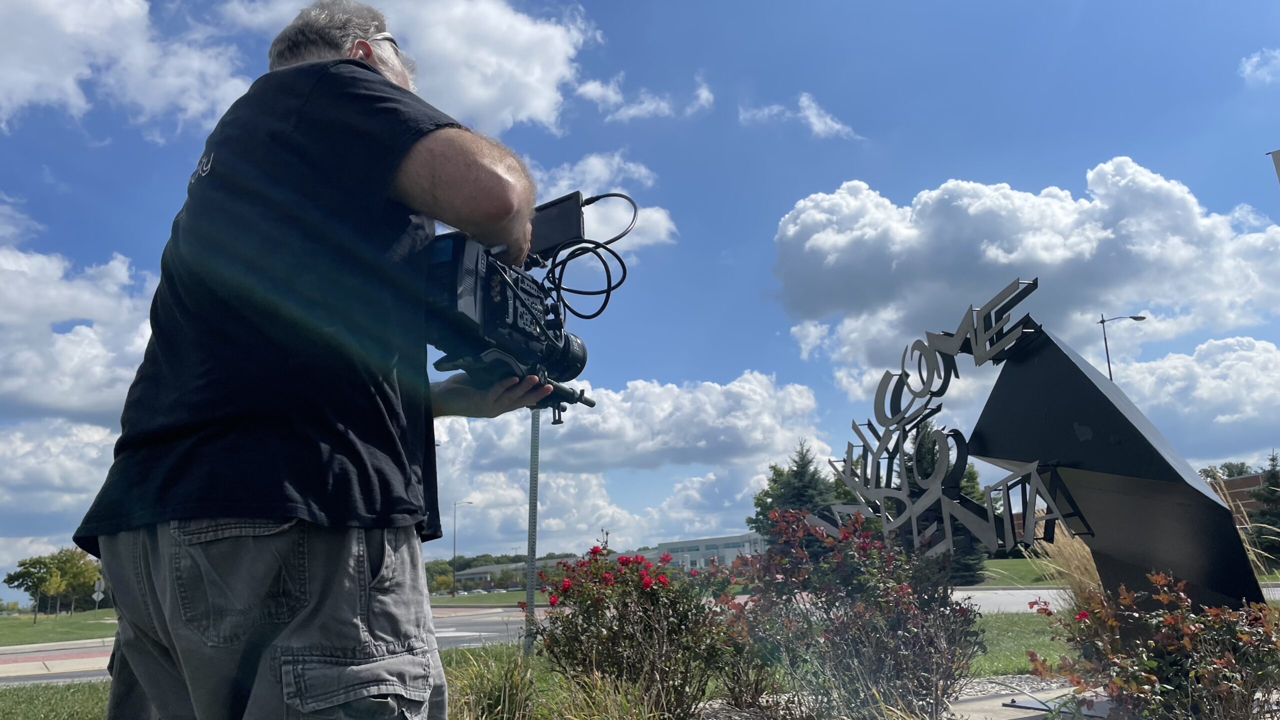 Dave Filming the Welcome to Penta Sign